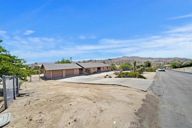 7575 Whitney Ave, Yucca Valley, CA 92284 - view of front of house featuring a mountain view and driveway