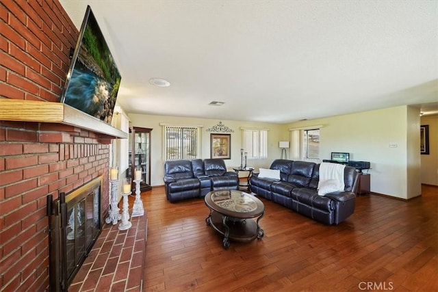 7575 Whitney Ave, Yucca Valley, CA 92284 - living area featuring healthy amount of natural light, a fireplace, and wood-type flooring