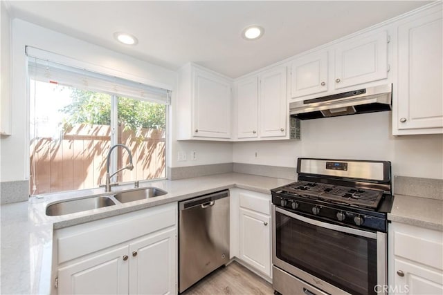 18 Rue Brittany, Lake Forest, CA 92610 - kitchen with stainless steel appliances, under cabinet range hood, light countertops, white cabinetry, and recessed lighting