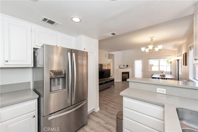 18 Rue Brittany, Lake Forest, CA 92610 - kitchen with stainless steel fridge with ice dispenser, light countertops, light wood finished floors, white cabinetry, and recessed lighting