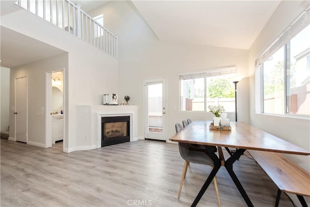 18 Rue Brittany, Lake Forest, CA 92610 - dining room featuring light wood-style floors, a fireplace, and high vaulted ceiling