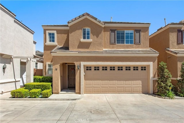 18 Rue Brittany, Lake Forest, CA 92610 - view of front facade with stucco siding, concrete driveway, and an attached garage