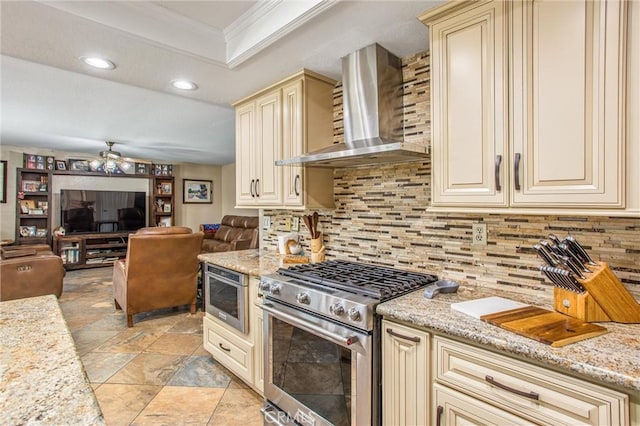 10735 Juniper Ave, Fontana, CA 92337 - kitchen with cream cabinets, gas range, wall chimney exhaust hood, ornamental molding, and open floor plan