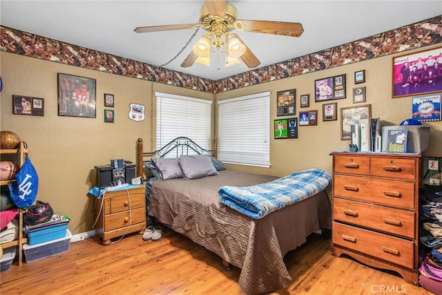 10735 Juniper Ave, Fontana, CA 92337 - bedroom with light wood-style floors, a textured wall, and ceiling fan