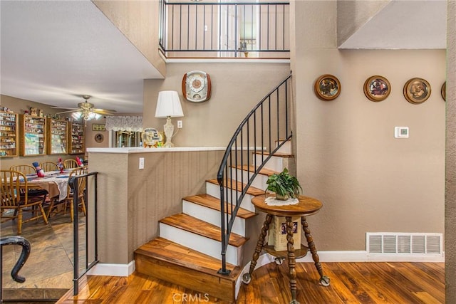 10735 Juniper Ave, Fontana, CA 92337 - staircase featuring wood finished floors, ceiling fan, and a textured wall