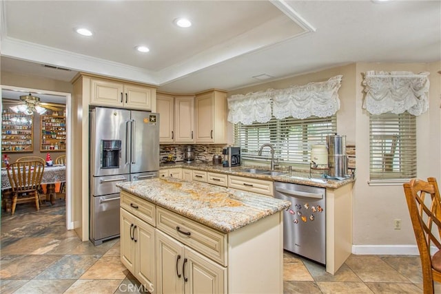 10735 Juniper Ave, Fontana, CA 92337 - kitchen featuring appliances with stainless steel finishes, cream cabinetry, crown molding, light stone counters, and ceiling fan