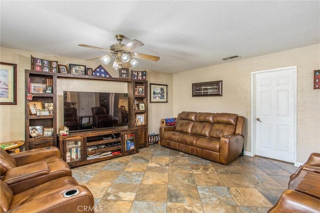 10735 Juniper Ave, Fontana, CA 92337 - living area featuring ceiling fan, stone tile flooring, and a textured ceiling