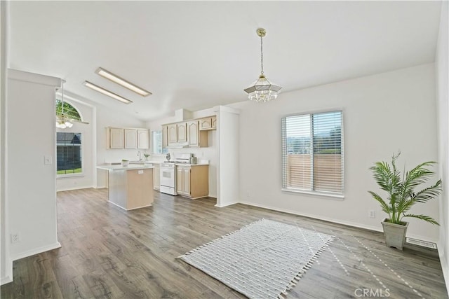 20060 Canyon View Dr, Canyon Country, CA 91351 - kitchen with white gas range oven, a kitchen island, light countertops, lofted ceiling, and light brown cabinets