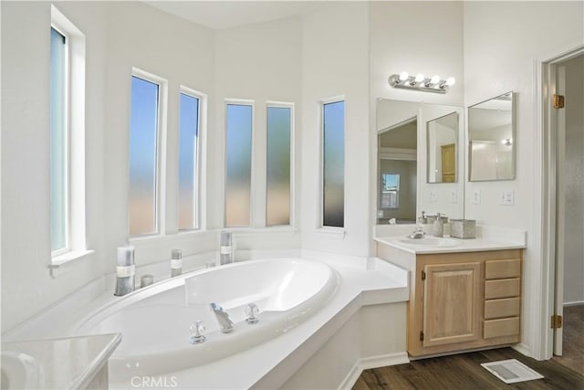 20060 Canyon View Dr, Canyon Country, CA 91351 - bathroom with vanity, a garden tub, and wood finished floors