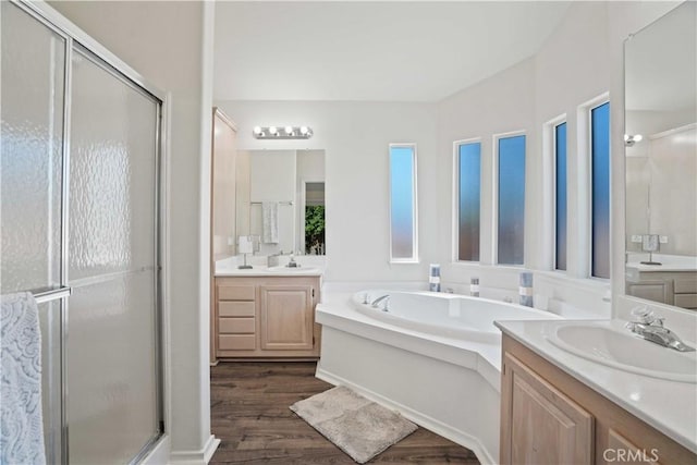 20060 Canyon View Dr, Canyon Country, CA 91351 - bathroom featuring two vanities, a stall shower, a garden tub, and wood finished floors