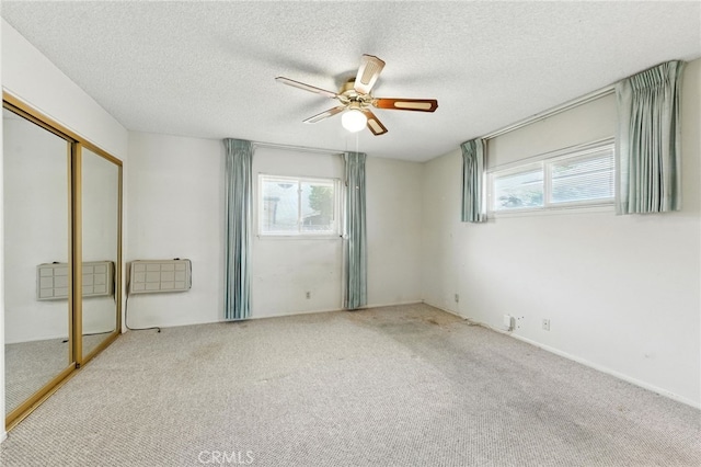 1181 Sandlewood Dr, Hemet, CA 92543 - unfurnished bedroom with carpet, a closet, a textured ceiling, and a ceiling fan