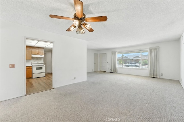 1181 Sandlewood Dr, Hemet, CA 92543 - unfurnished living room featuring light colored carpet, a ceiling fan, and a textured ceiling