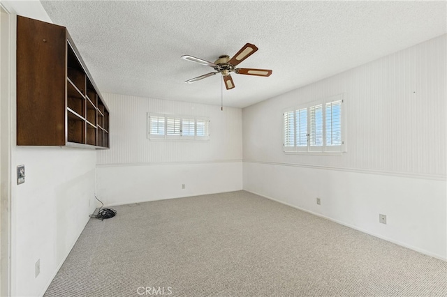 1181 Sandlewood Dr, Hemet, CA 92543 - carpeted empty room featuring a ceiling fan and a textured ceiling