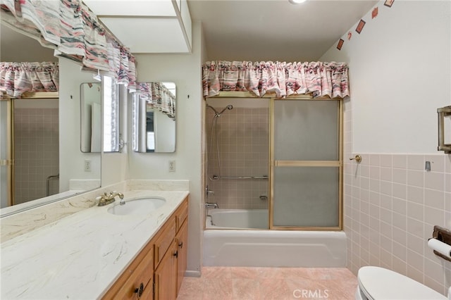 1181 Sandlewood Dr, Hemet, CA 92543 - bathroom featuring tile walls, vanity, tile patterned flooring, and bath / shower combo with glass door