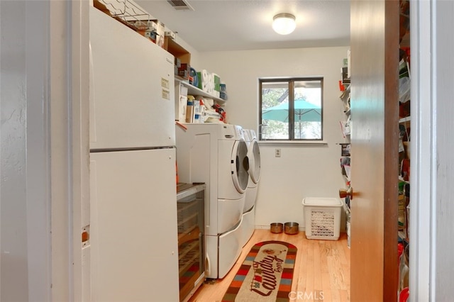 35484 Rd 274, North Fork, CA 93643 - laundry area featuring washing machine and dryer and wood finished floors