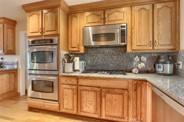 35484 Rd 274, North Fork, CA 93643 - kitchen featuring appliances with stainless steel finishes, light wood finished floors, and backsplash