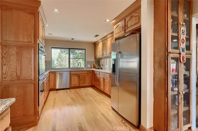35484 Rd 274, North Fork, CA 93643 - kitchen with stainless steel appliances, light wood-style floors, backsplash, glass insert cabinets, and recessed lighting
