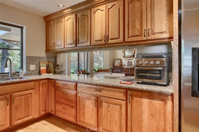 35484 Rd 274, North Fork, CA 93643 - kitchen with stainless steel refrigerator, light stone counters, light wood-type flooring, tasteful backsplash, and recessed lighting