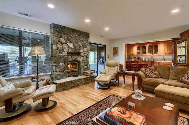 35484 Rd 274, North Fork, CA 93643 - living room featuring wood finished floors, a stone fireplace, plenty of natural light, and recessed lighting