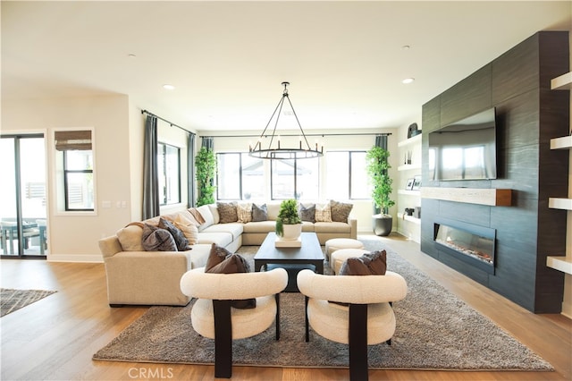 7051 Hurley Ct, San Bernardino, CA 92407 - living area with light wood-style flooring, a fireplace, and recessed lighting