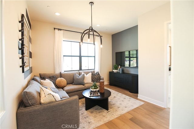 7051 Hurley Ct, San Bernardino, CA 92407 - living area featuring light wood-style floors, a chandelier, and recessed lighting