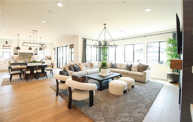 7051 Hurley Ct, San Bernardino, CA 92407 - living room with light wood-style floors, healthy amount of natural light, recessed lighting, and a chandelier