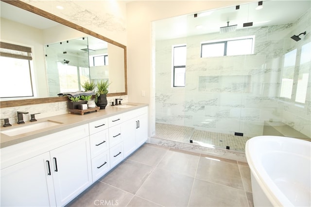 7051 Hurley Ct, San Bernardino, CA 92407 - bathroom featuring a shower stall, a freestanding tub, double vanity, and tile patterned floors