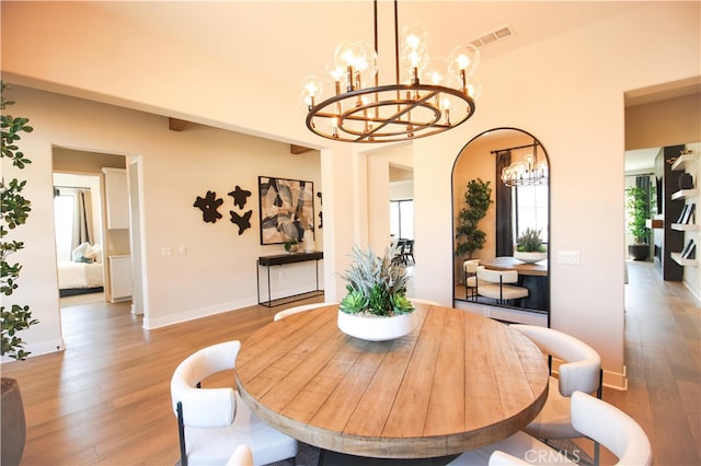 7051 Hurley Ct, San Bernardino, CA 92407 - dining space featuring a chandelier and light wood-type flooring