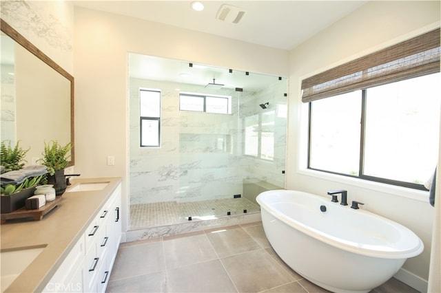 7051 Hurley Ct, San Bernardino, CA 92407 - bathroom with a tile shower, double vanity, a freestanding bath, and tile patterned flooring