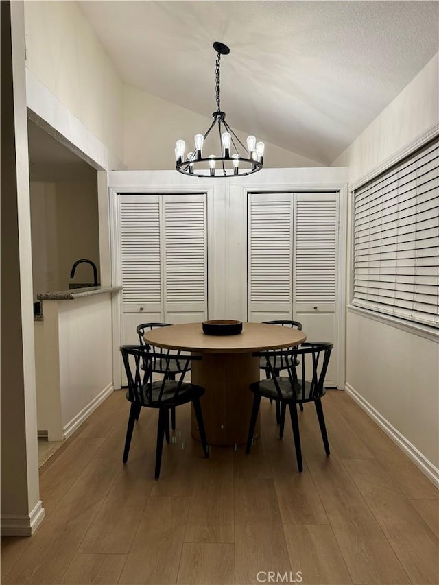 16040 Leffingwell Rd Unit 78, Whittier, CA 90603 - dining room with lofted ceiling, a chandelier, and wood finished floors