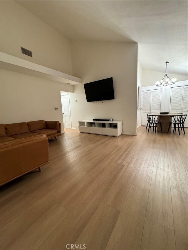 16040 Leffingwell Rd Unit 78, Whittier, CA 90603 - living room with a chandelier, wood finished floors, and high vaulted ceiling