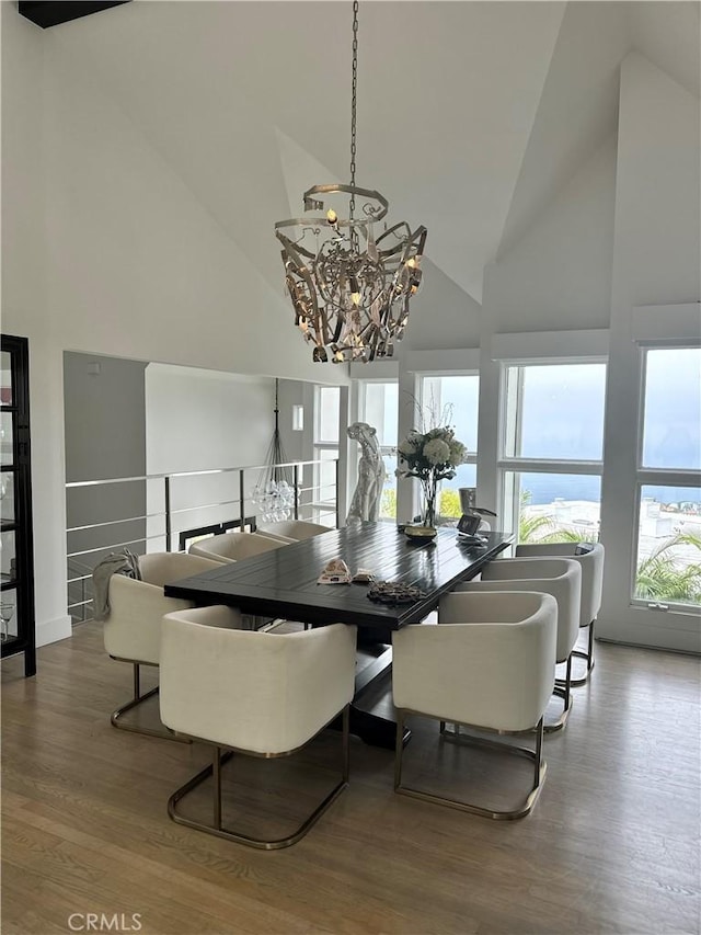 766 Pelican Dr, Laguna Beach, CA 92651 - dining area with high vaulted ceiling, a chandelier, and wood finished floors
