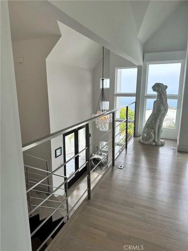 766 Pelican Dr, Laguna Beach, CA 92651 - hallway featuring an upstairs landing, a chandelier, lofted ceiling, and wood finished floors