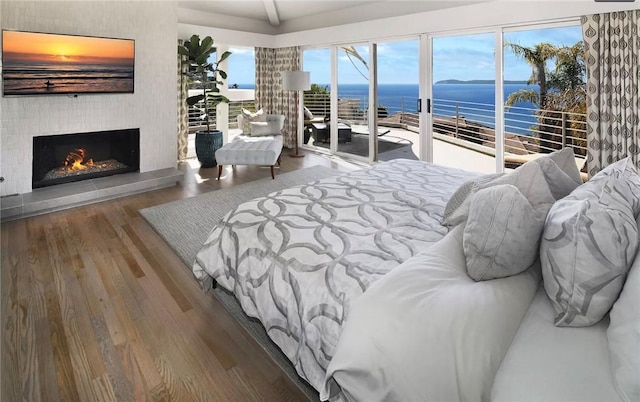 766 Pelican Dr, Laguna Beach, CA 92651 - bedroom featuring a water view, access to outside, wood finished floors, and a large fireplace