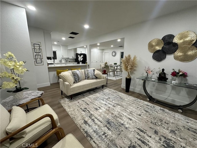 1598 W 7th St, San Bernardino, CA 92411 - living area featuring dark wood-style floors and recessed lighting
