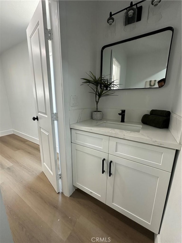 1598 W 7th St, San Bernardino, CA 92411 - bathroom featuring wood finished floors and vanity