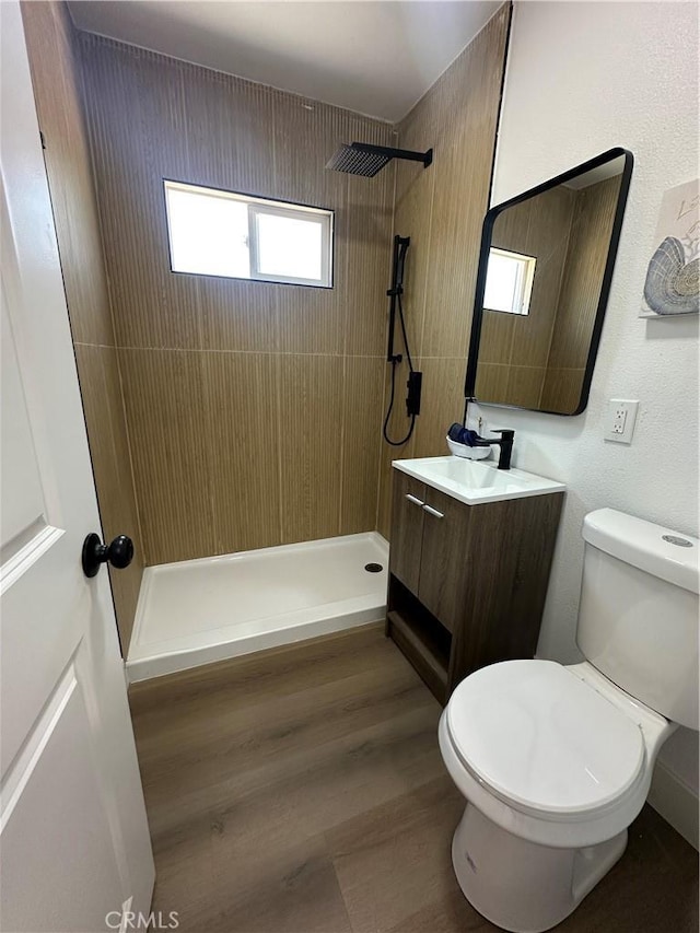 1598 W 7th St, San Bernardino, CA 92411 - bathroom with a tile shower, vanity, and wood finished floors