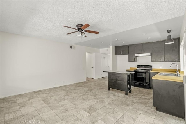 1824 Greenleaf Dr, West Covina, CA 91792 - kitchen with black range with electric stovetop, under cabinet range hood, ceiling fan, light countertops, and a textured ceiling