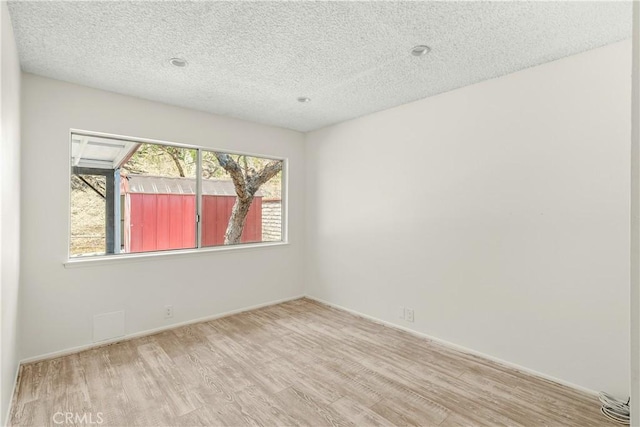 1824 Greenleaf Dr, West Covina, CA 91792 - empty room with wood finished floors and a textured ceiling
