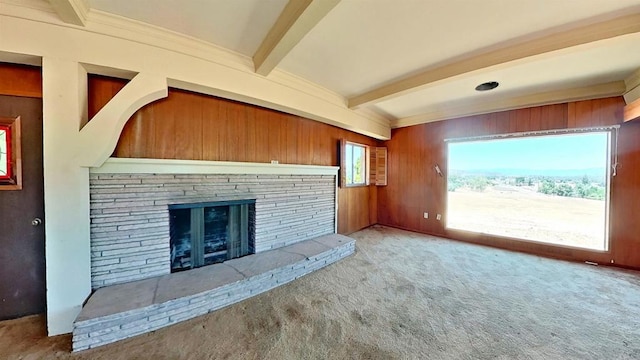 700 Ash St, Ramona, CA 92065 - unfurnished living room featuring beam ceiling, carpet floors, a stone fireplace, and wood walls
