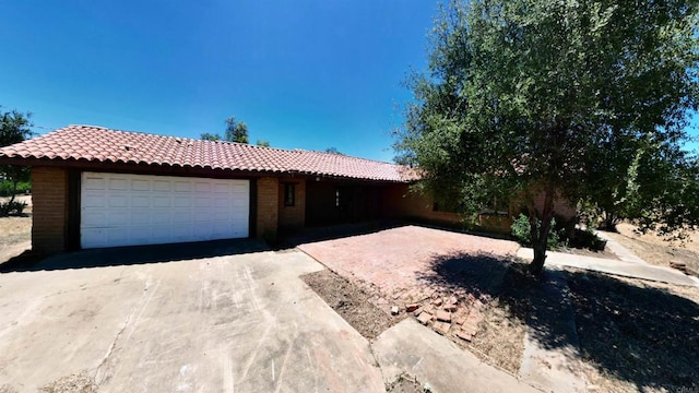 700 Ash St, Ramona, CA 92065 - single story home with a tile roof, a garage, brick siding, and concrete driveway