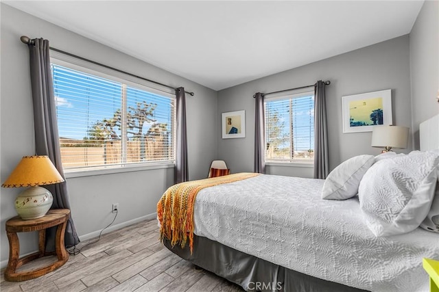 2654 Olympic Rd, Joshua Tree, CA 92252 - bedroom featuring wood finished floors and baseboards