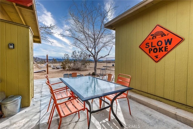 2654 Olympic Rd, Joshua Tree, CA 92252 - view of patio / terrace featuring outdoor dining space and a mountain view