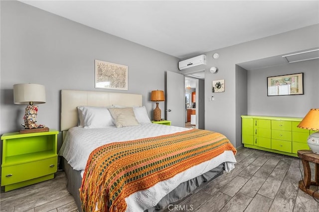 2654 Olympic Rd, Joshua Tree, CA 92252 - bedroom with a wall unit AC, wood finished floors, and attic access