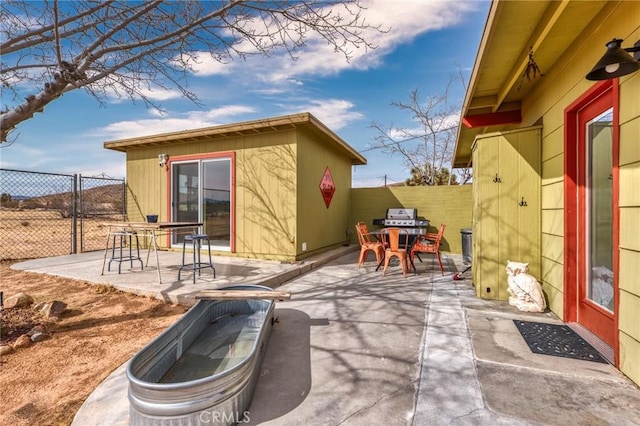 2654 Olympic Rd, Joshua Tree, CA 92252 - fenced backyard featuring a patio area, an outbuilding, and outdoor dining area