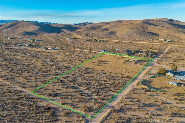 2654 Olympic Rd, Joshua Tree, CA 92252 - aerial view of property and surrounding area with property boundaries highlighted, a mountain backdrop, and rural landscape