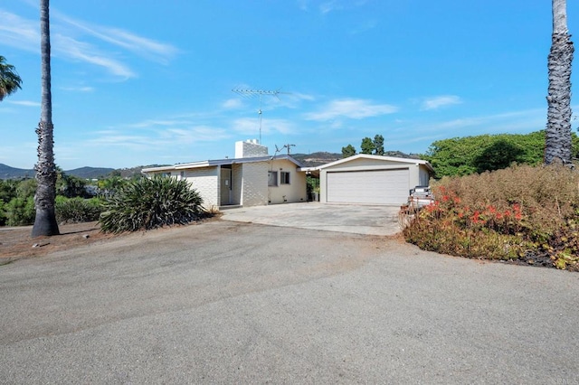 2151 Catalina Ave, Vista, CA 92084 - ranch-style house featuring an outbuilding, a chimney, concrete driveway, brick siding, and an attached garage