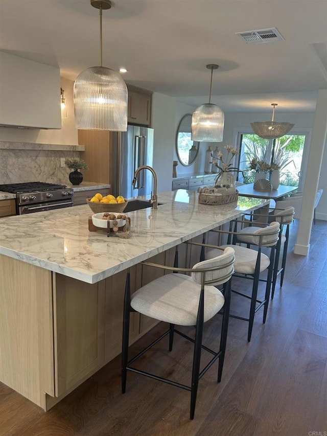 4051 Avenida Brisa, Rancho Santa Fe, CA 92091 - kitchen featuring high quality appliances, dark wood-style floors, light stone counters, backsplash, and a kitchen breakfast bar