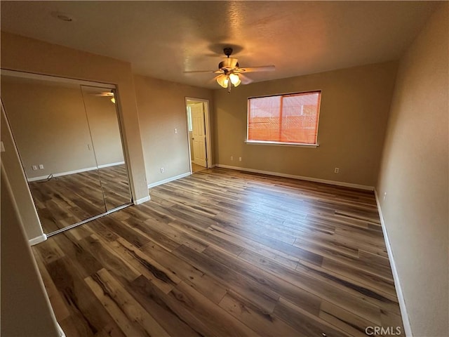 2240 Spring Valley Rd, Clearlake Oaks, CA 95423 - unfurnished bedroom featuring wood finished floors, a closet, and a ceiling fan