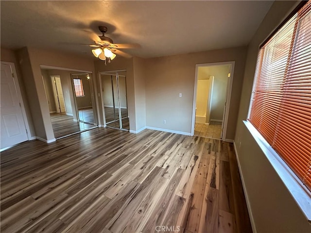2240 Spring Valley Rd, Clearlake Oaks, CA 95423 - unfurnished bedroom featuring wood finished floors and a ceiling fan